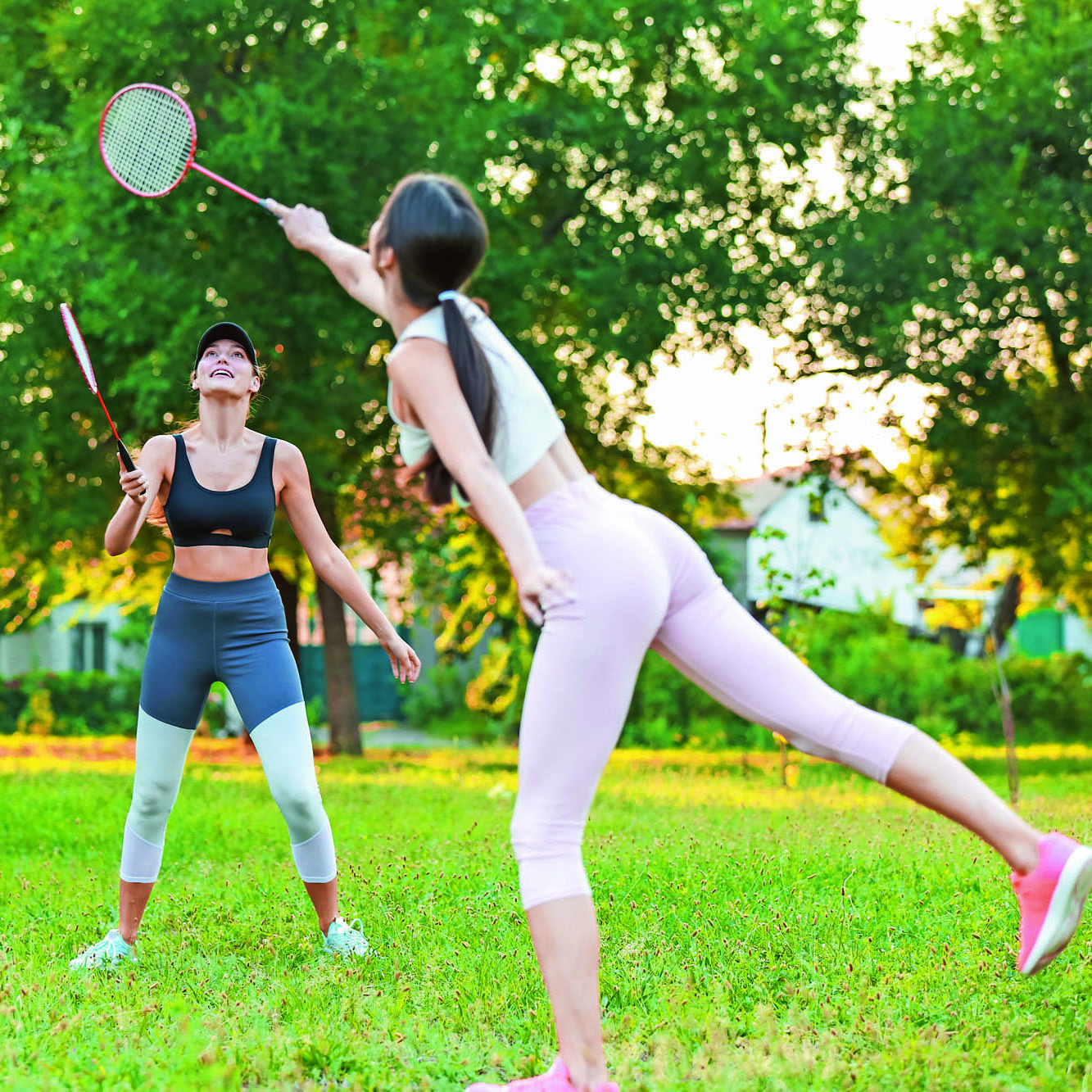 Young women playing badminton outdoors